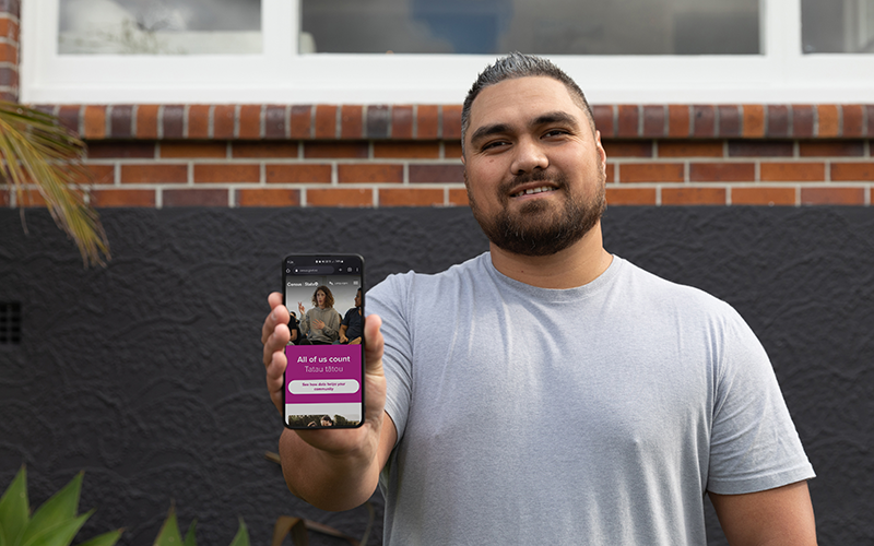 Man holds up phone showing online 2023 Census