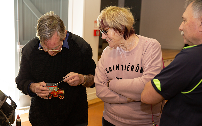 Repair Café volunteer, Ray Wales, repairs an antique toy
