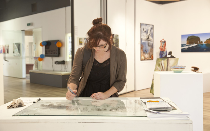 Photo of person at Percy Thomson Gallery exhibition