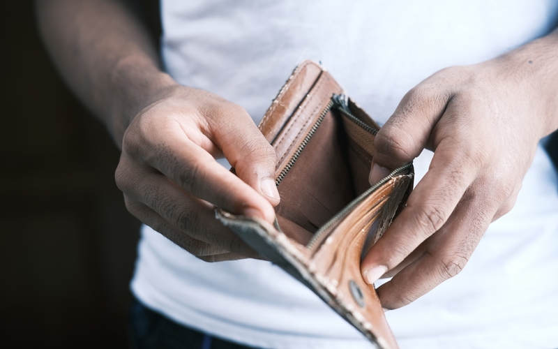 Photo of man opening wallet
