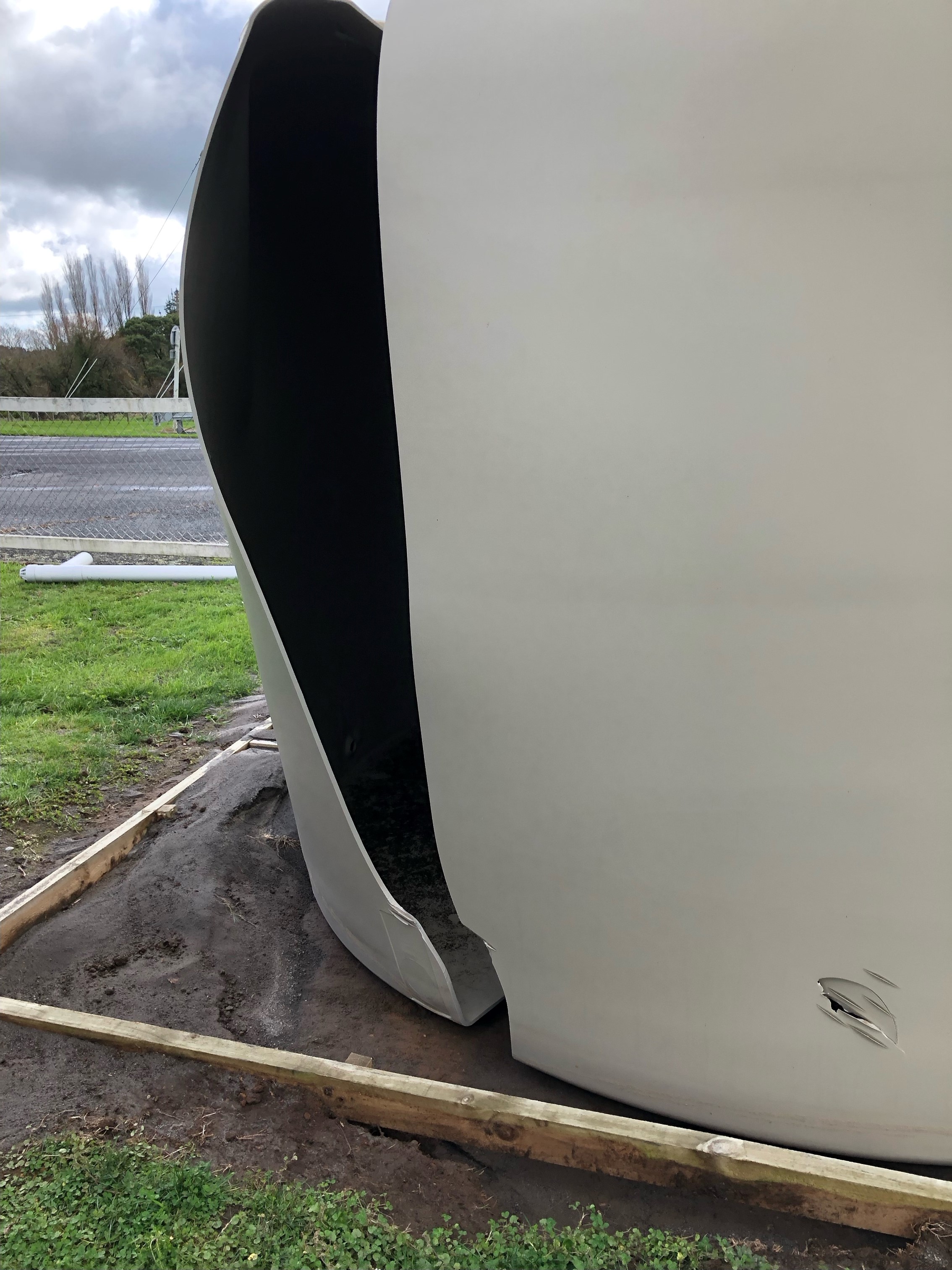 Water tank damage, photo shows a large cut in the tank splitting it open.
