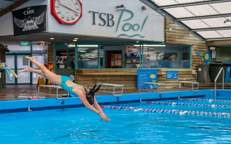 Woman diving into TSB Pool Complex